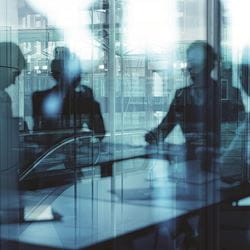 A group of professionals sitting in a meeting.