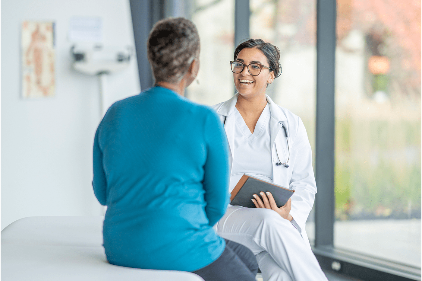 A woman doctor talking to a woman patient.